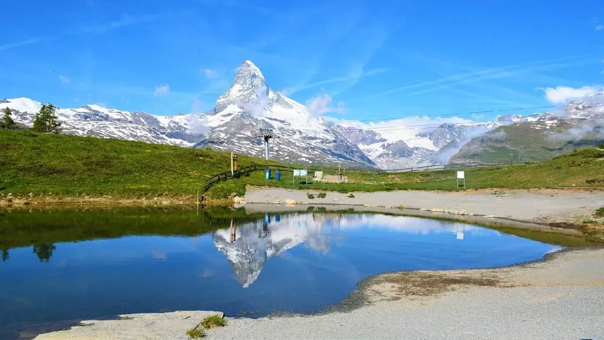 View of lake leisee, surrounded by alpine peaks and great view of Matterhorn