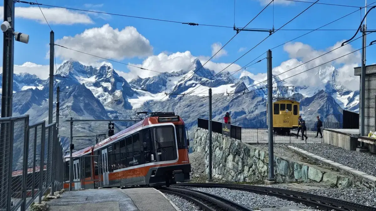 View of Gornergrat Railway in Zermatt and The alpine ranges at the background