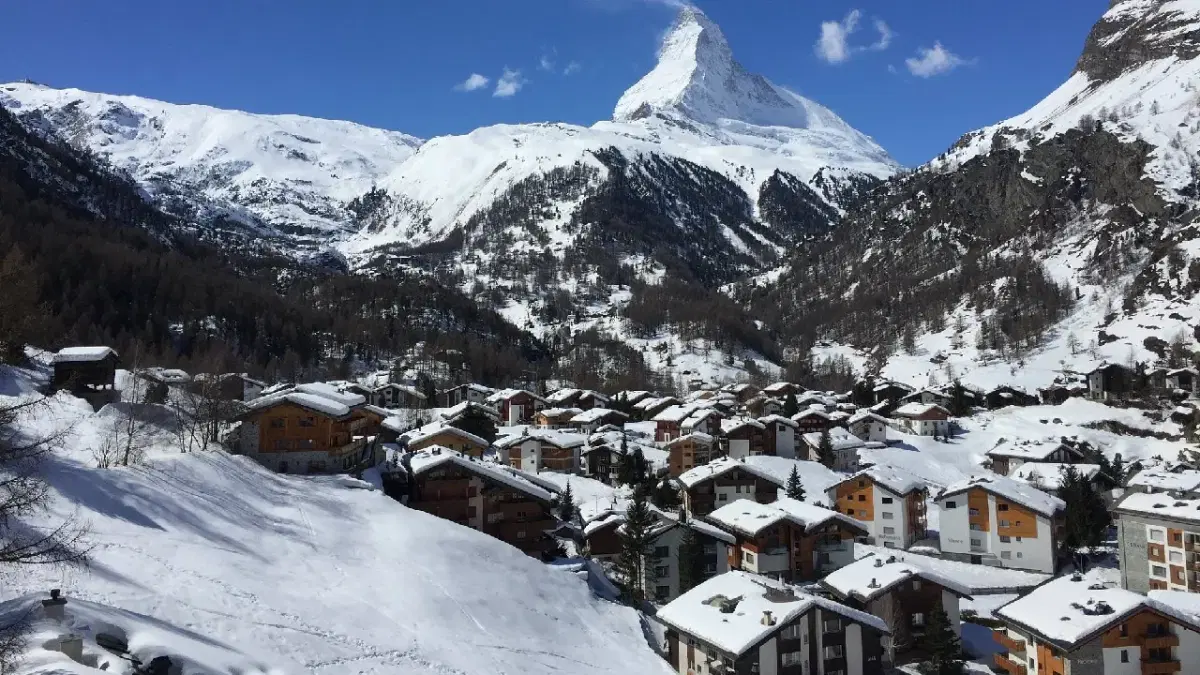 View of Zermatt houses with matterhorn at the background covered with snow