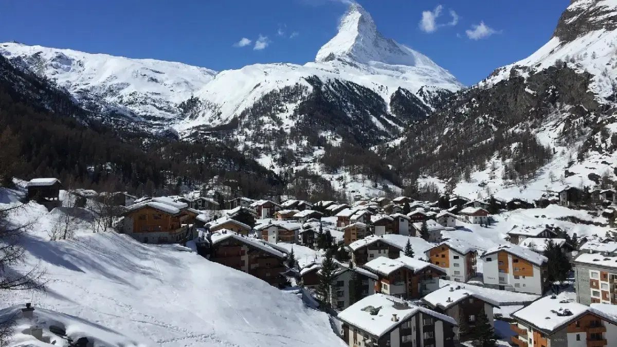 View of Zermatt houses with matterhorn at the background covered with snow