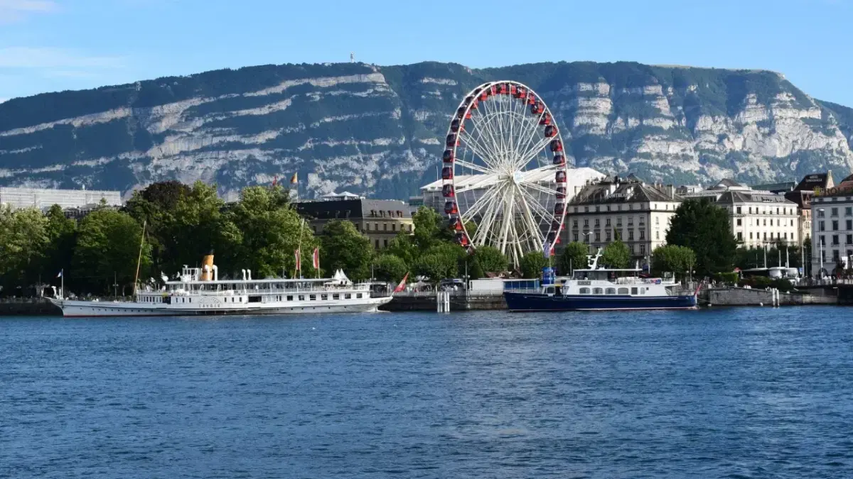 View of giant wheel and the cruises in lake Geneva.