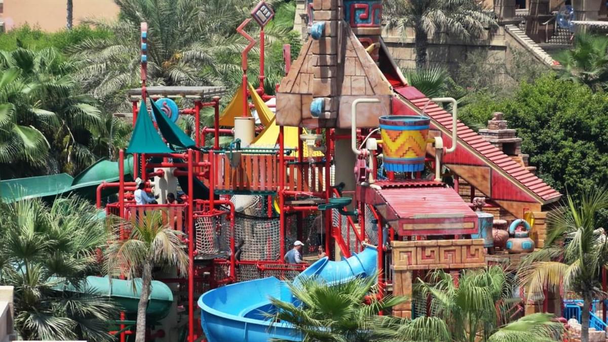 Colorful multi-level play structure and water slides at Atlantis Aquaventure, Dubai’s largest waterpark.