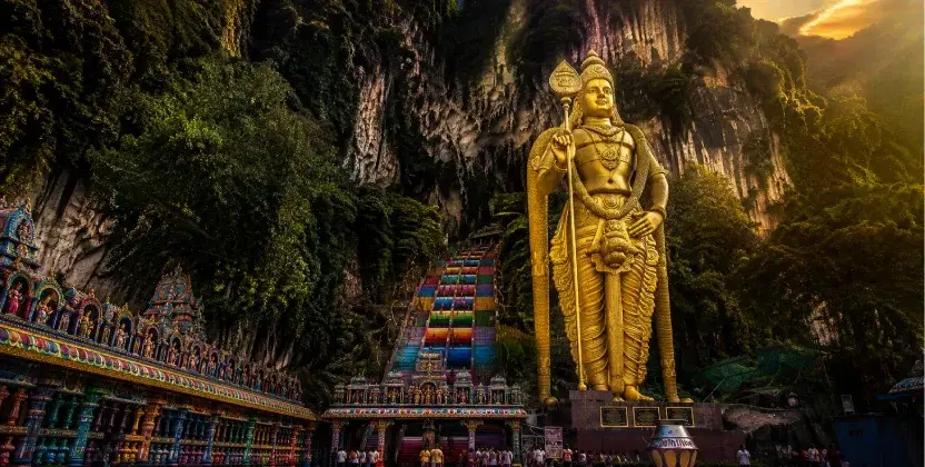 Tourists visit Batu Caves and its golden statue while Genting Highlands cable cars