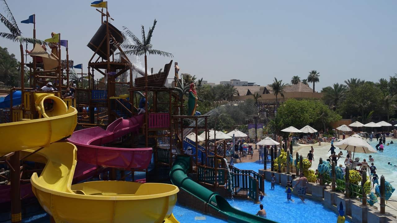 Bright yellow slides and splash zones at a Dubai waterpark, ideal for family-friendly fun.