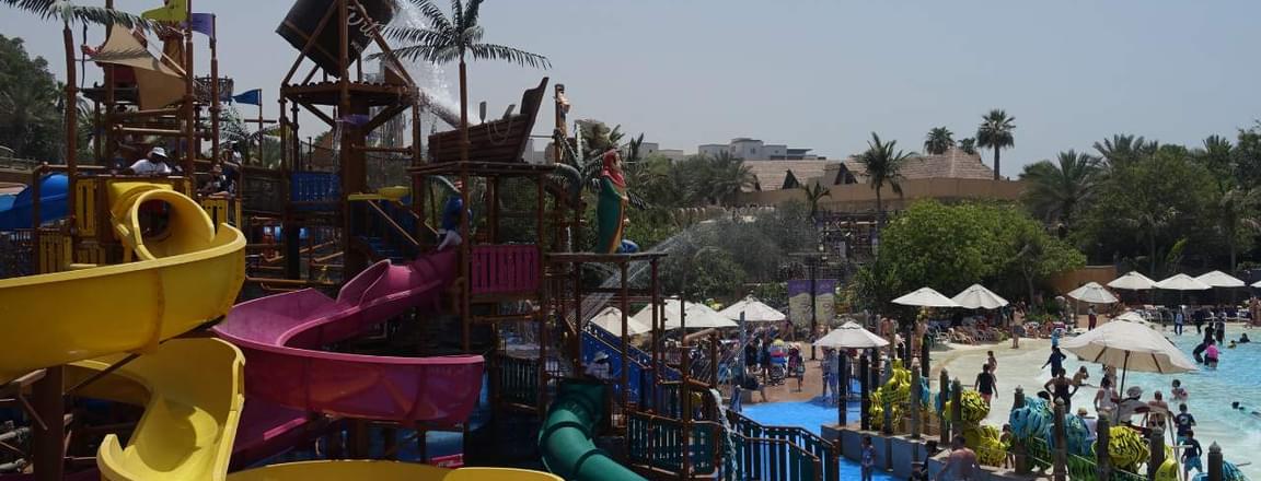 Bright yellow slides and splash zones at a Dubai waterpark, ideal for family-friendly fun.